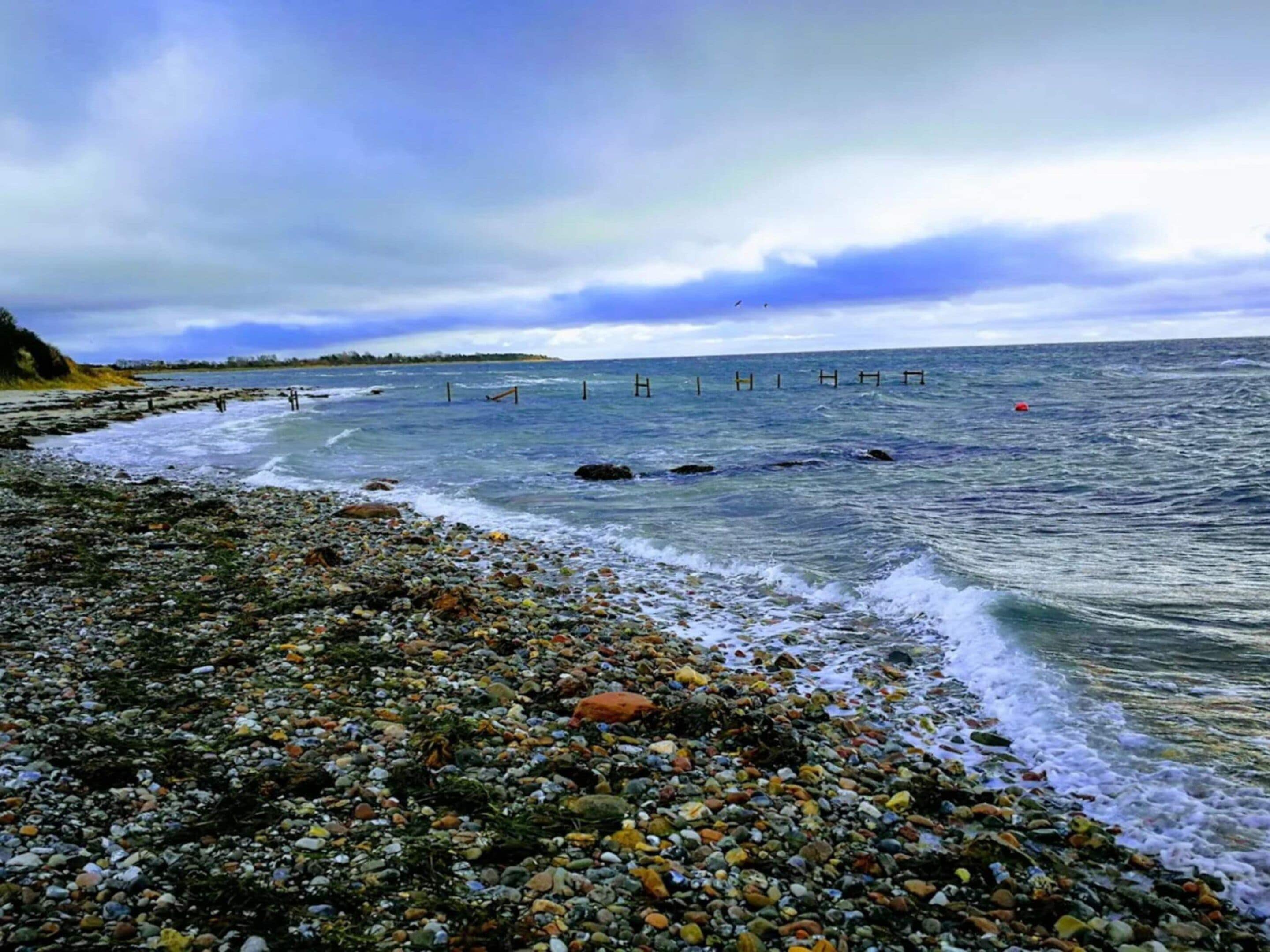 A rocky beach with waves crashing onto the shore.