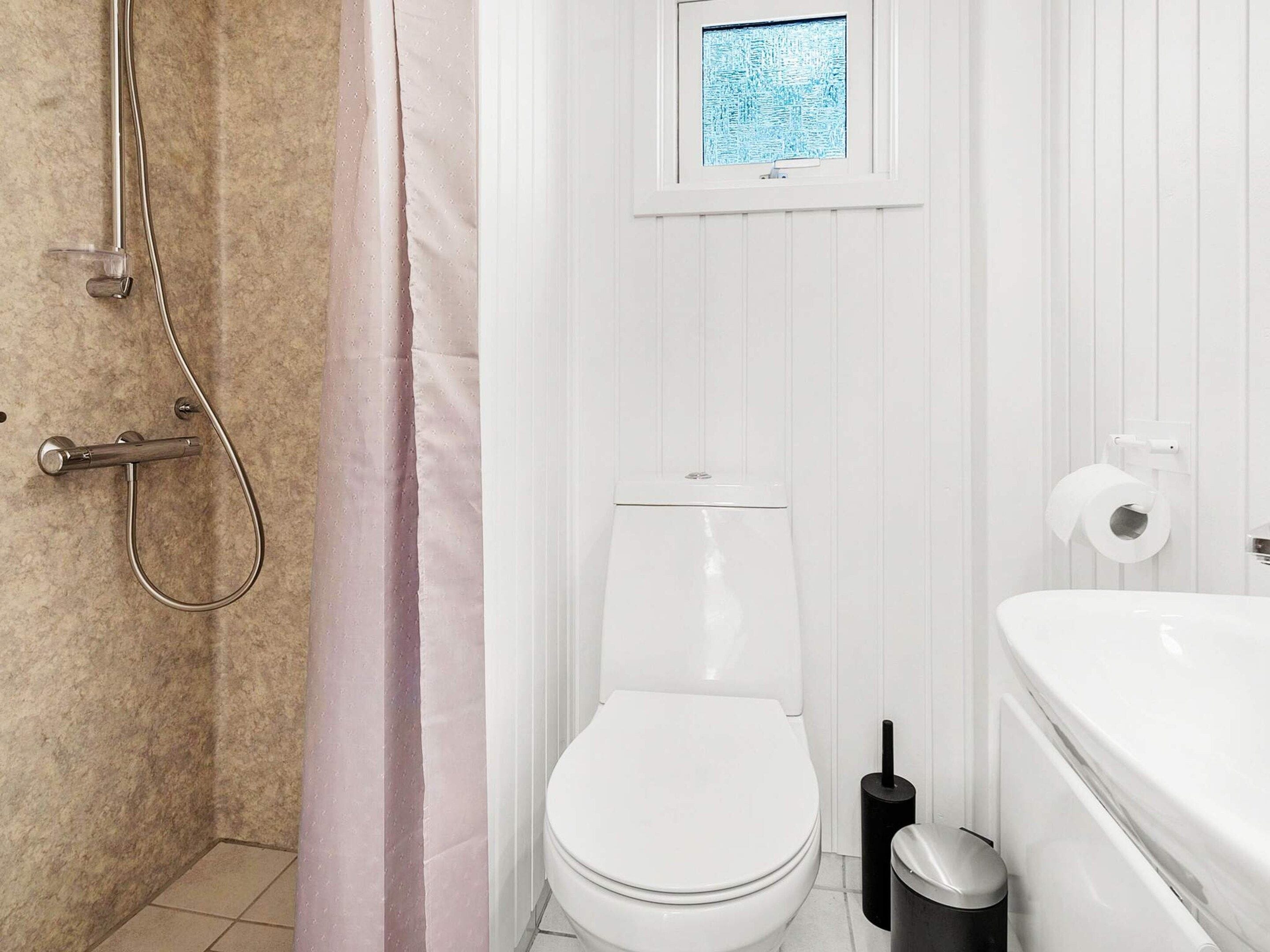 Ein Badezimmer mit Dusche, Toilette und Badewanne.