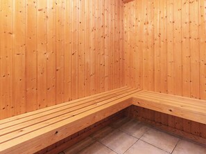 A sauna with wooden walls and benches. - 4 Star Holiday Home in Idestrup (Idestrup)