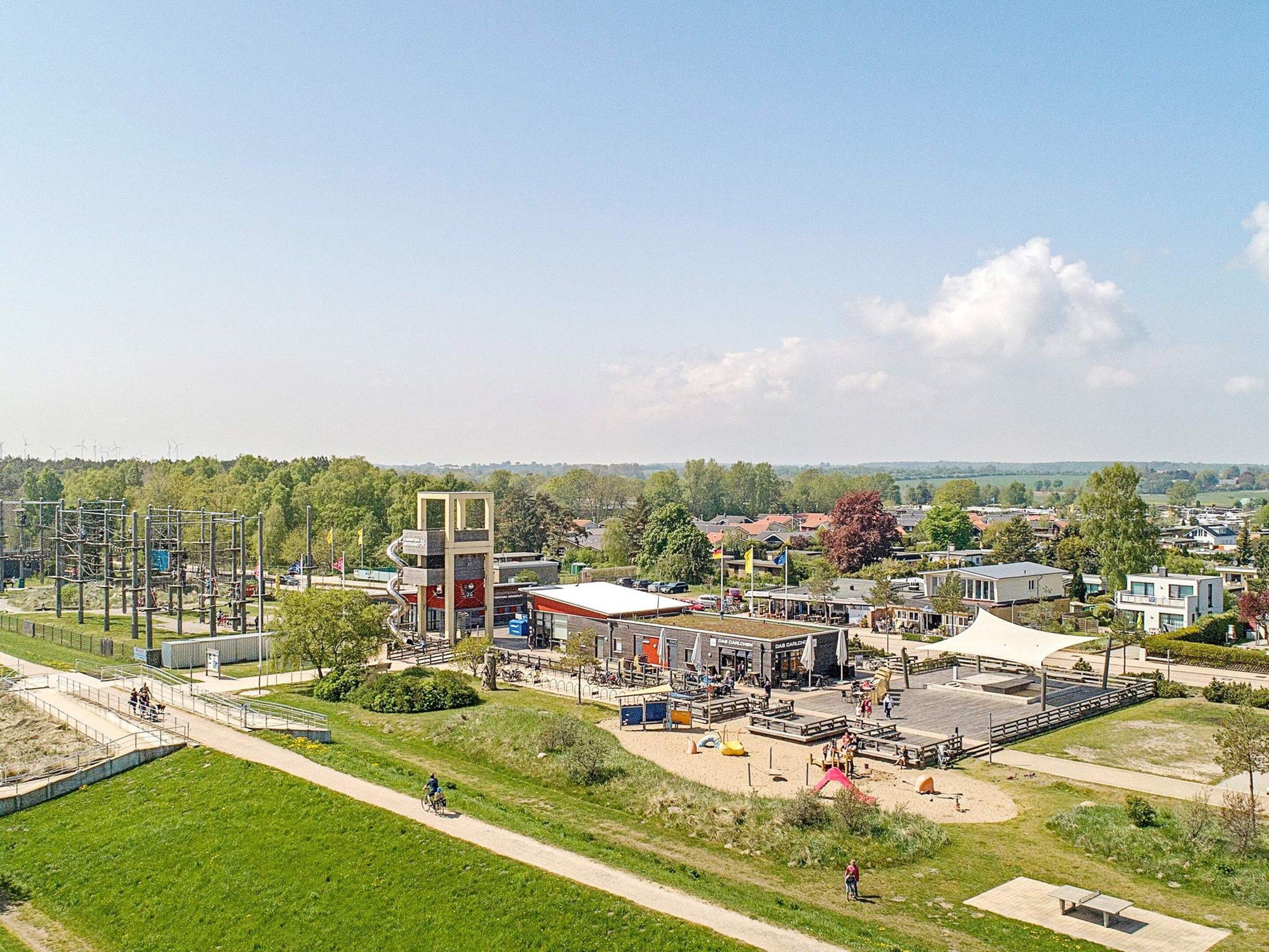 A park with a playground, picnic areas, and a large open space for gatherings.