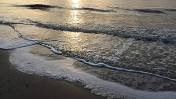 A beach with waves gently lapping onto the shore.
