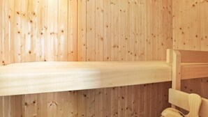 A wooden sauna bench with a bench seat and backrest.