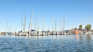 A marina with multiple sailboats docked.