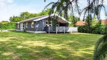 Stroll onto the charming front porch of this cozy home, surrounded by a beautifully manicured lawn.