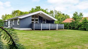 A single-story house with a sloped roof and a covered porch.