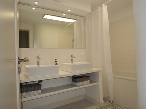 Bathtub, hair dryer, towels, soap