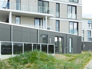 A multi-story residential building with balconies, large windows, and a flat roof. - Holiday Home in Wendtorf (Wendtorf)