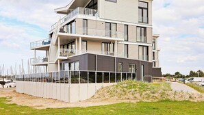 A multi-story residential building with balconies and large windows. - Holiday Home in Wendtorf (Wendtorf)