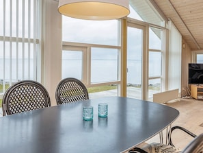 A dining area with a table, chairs, and a television. - 5 Star Holiday Home in Vinderup (Vinderup)