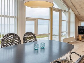 A dining area with a table, chairs, and a television. - 5 Star Holiday Home in Vinderup (Vinderup)