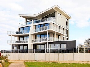 A multi-story building with balconies, large windows, and a flat roof. - Holiday Home in Wendtorf (Schönberg)