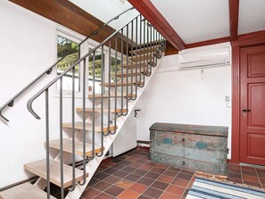 A staircase with metal railings and wooden steps, leading to a door with a red frame. - Peaceful Holiday Home in Skagen near Sea (Skagen)