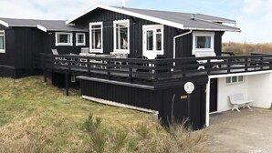 A black and white building with multiple windows and a covered outdoor area. - Peaceful Holiday Home in Skagen near Sea (Skagen)