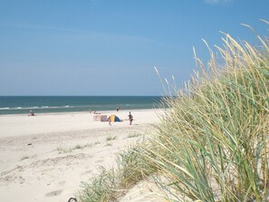 A beach with a tent and people. - Spacious Holiday Home in Blavand Denmark With Sauna (Blavand)