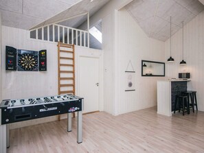 A spacious loft with a foosball table, dartboards, and a loft bed. - 5 Star Holiday Home in Blavand (Blavand)