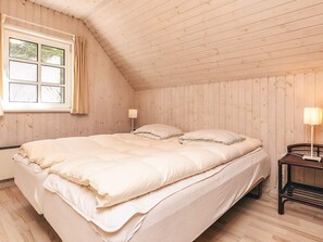 A room with a bed, a window, and a nightstand. - 5 Star Holiday Home in Vaeggerlose (Vaeggerlose)