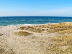 A beach with a lifebuoy and a sandy shore.
