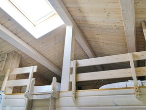 A wooden interior with a sloped ceiling and skylight. - Stylish Holiday Home in Føllenslev near Sea (Follenslev)