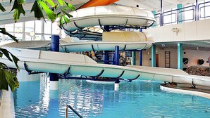 An indoor pool with multiple slides and a central water feature. - Gorgeous Holiday Home in Ringkøbing With Terrace (Ringkobing)