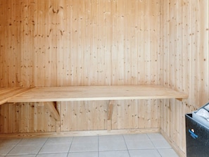 A room with a wooden wall, a wooden bench, and a tiled floor. - 4 Star Holiday Home in Vaeggerlose (Vaeggerlose)