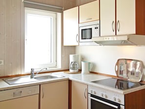 A kitchen with a Siemens microwave, Bosch coffee maker, and a toaster.