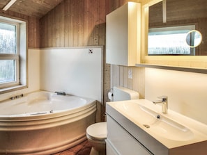 Bathroom features a bathtub, toilet, and sink with a window above.