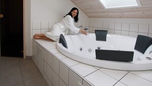 A modern bathroom with a skylight, a freestanding bathtub, and a tiled floor. - Fabulous Holiday Home in Rodby Denmark near Sea (Rodby)