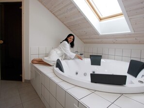 A modern bathroom with a skylight, a freestanding bathtub, and a tiled floor. - Fabulous Holiday Home in Rodby Denmark near Sea (Rodby)