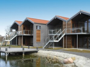 A modern building with multiple balconies and staircases leading to upper floors.