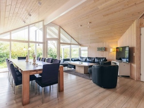A modern interior with a dining area, seating, and a television. - Attractive Holiday Home in Vaggerlose near Sea (Idestrup)