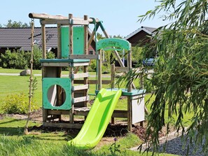 A playground with a slide and climbing structures. - Attractive Holiday Home in Vaggerlose near Sea (Idestrup)