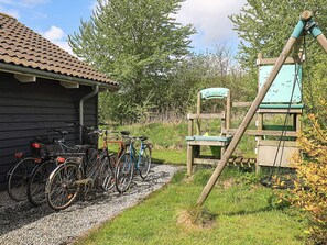 A gravel path leading to a wooden structure with bicycles parked nearby. - Attractive Holiday Home in Vaggerlose near Sea (Idestrup)