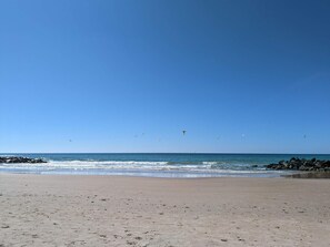A beach with a clear sky, calm sea, and rocky shoreline. - 4 Star Holiday Home in Hjorring (Hjørring)