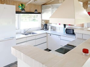 A modern kitchen with a dishwasher, a microwave, and a coffee maker. - 4 Star Holiday Home in Hjorring (Hjørring)