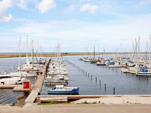 A marina with multiple boats docked in calm waters. - Holiday Home in Wendtorf (Schönberg)