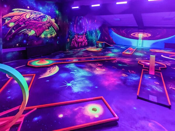 A room with a space-themed floor design, including planets and stars.