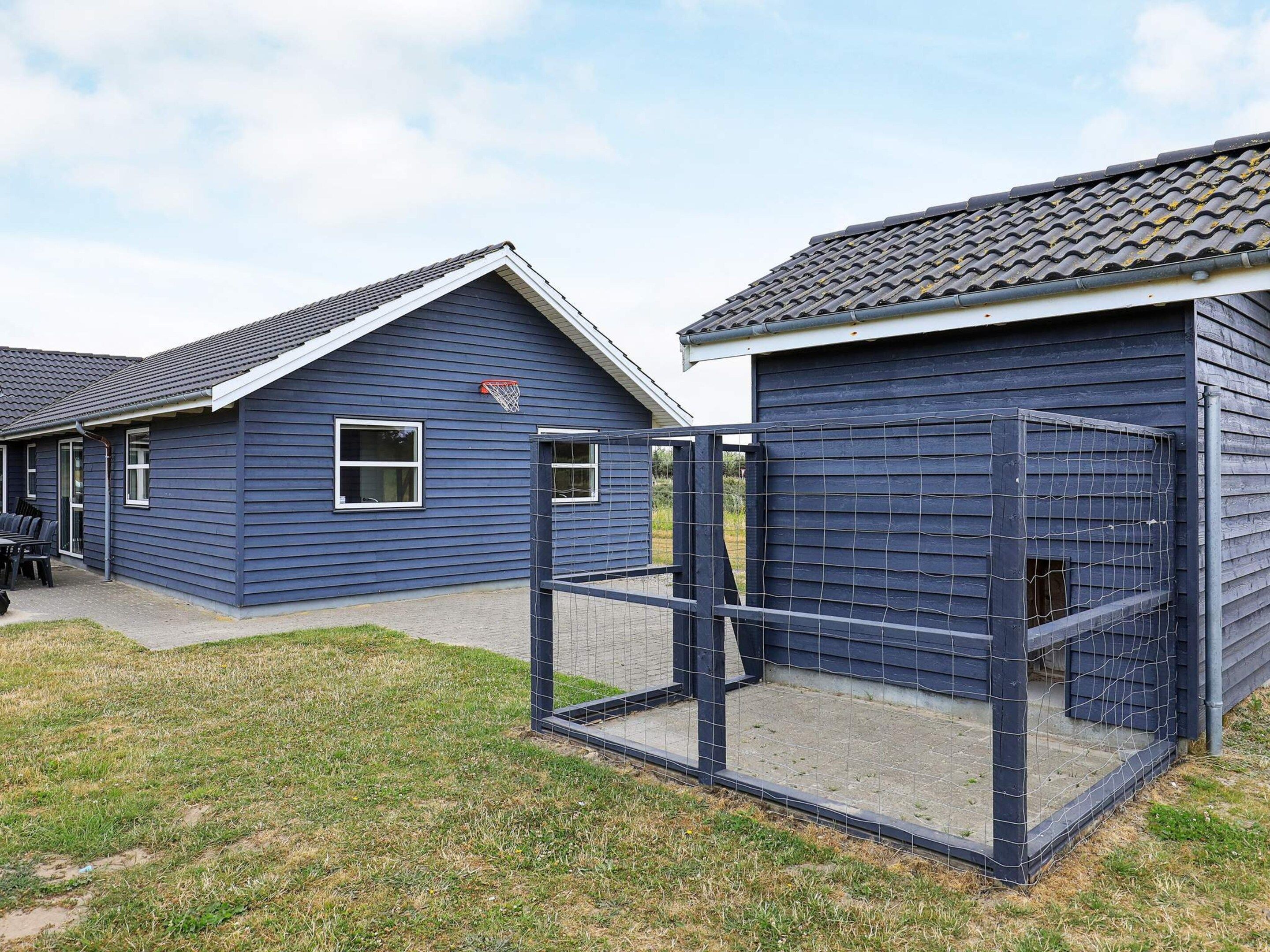 A residential area with two houses, one with a visible basketball hoop, and a fenced play area.