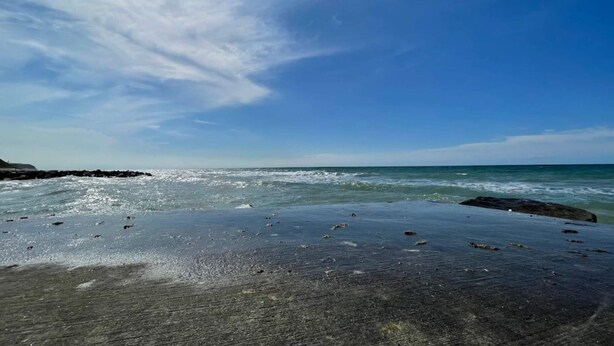 A beach with a clear sky, calm sea, and rocky shoreline. - 4 Star Holiday Home in Hjorring (Hjørring)
