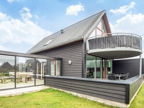A modern house with a large deck, a balcony, and a glass enclosure. - Comfy Holiday Home in Jutland near Sea (Rømø)