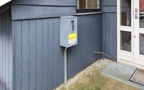 A building with a grey exterior, a door with a glass panel, and a small outdoor area with a step leading to the door. - 10 Person Holiday Home in Juelsminde-by Traum (Horsens)