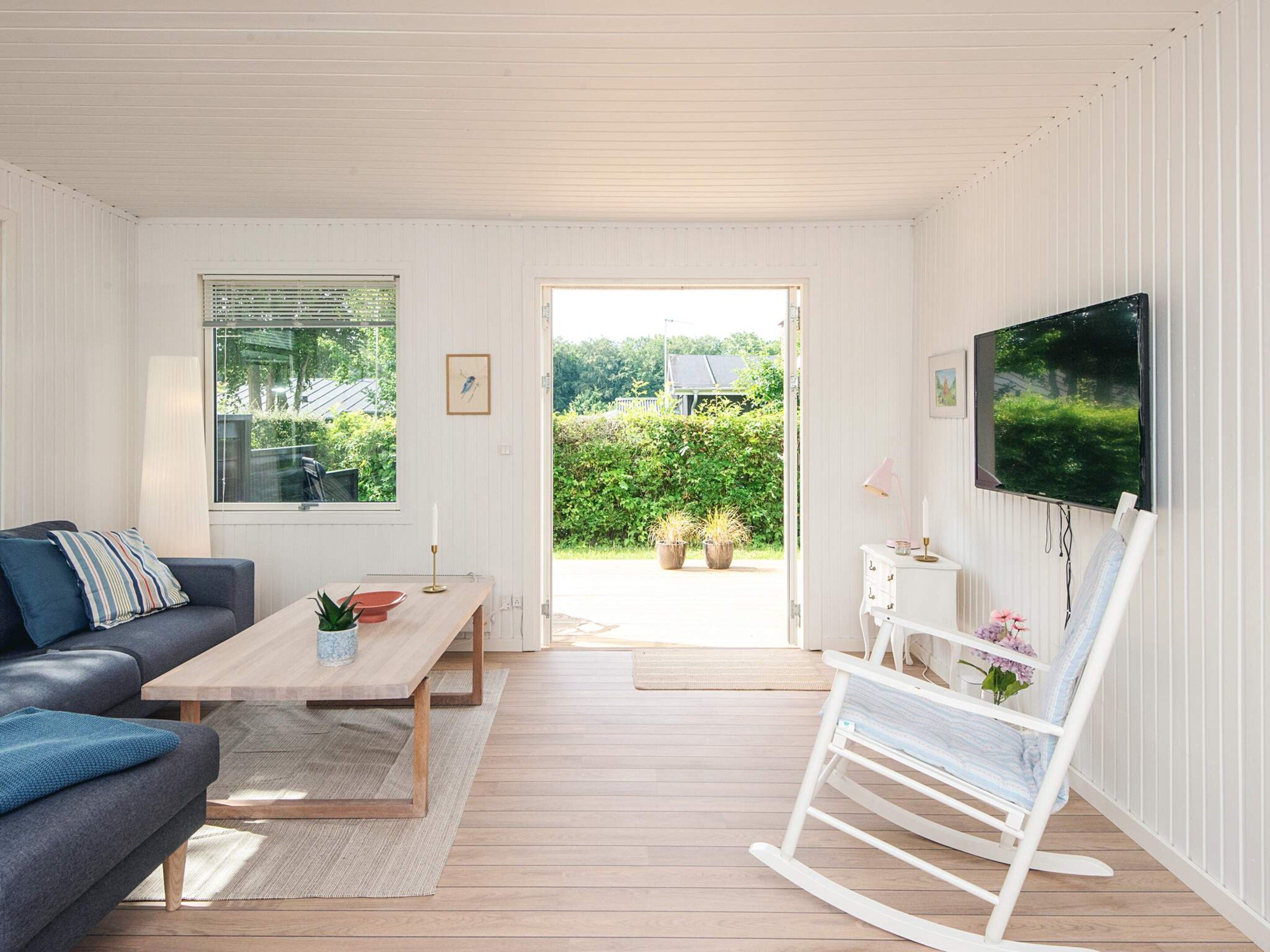 A modern living room with a sofa, coffee table, and a television.