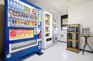 Convenient vending area with a refrigerator and a selection of beverages and snacks.