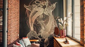 A modern interior with a large dragon mural, a brick wall, a wooden bench, and a window with natural light. - 36 Phô Cô Hotel & Suites (Weimar)