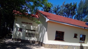 A two-story building with a red-tiled roof and a sign that reads "MARYLAND HOTEL". - Maryland Hotel Kisumu (Kisumu)
