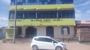 A building with a sign for 'Millennium Guest House & Restaurant' and a 'Hotel & Bar' sign. - Millennium Guest House (Narok)