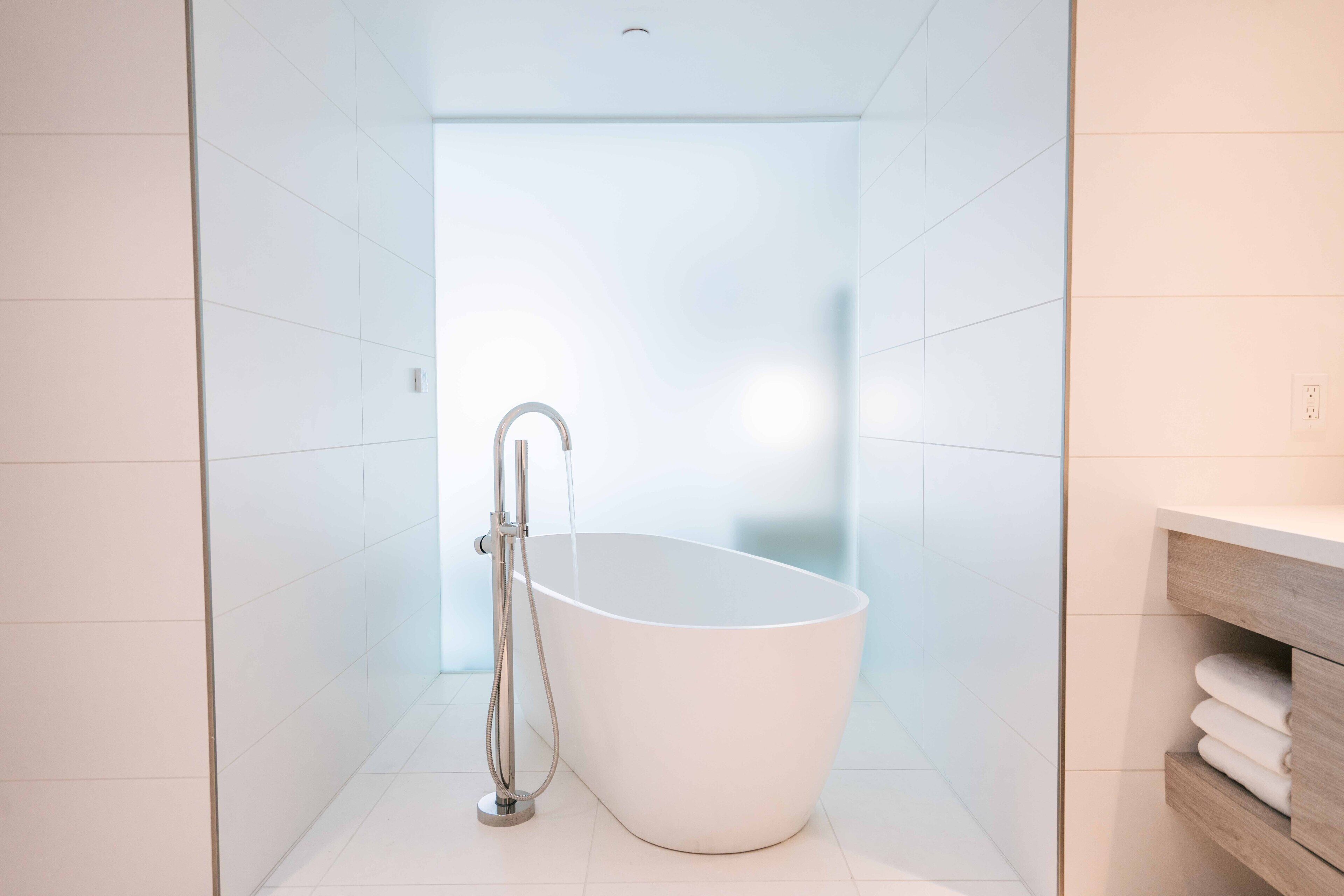 executive suite | bathroom | combined shower/bathtub, designer toiletries, hair dryer, dressing gowns