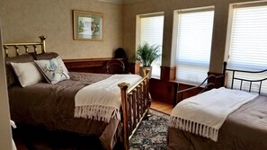 A bedroom with two beds, a wooden headboard, a framed picture on the wall, and a potted plant. - Beautiful Lake Front Home on 5 acres...multi family vacations (Kelseyville)