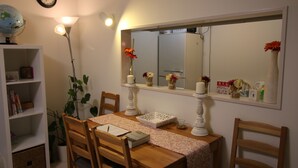 A dining area with a wooden table, chairs, a globe, and a bookshelf. - COCO Shinjuku (Tokyo)