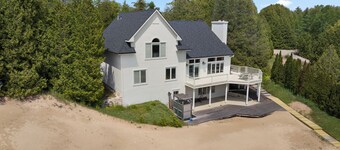 Stunning Lakefront with private sand beach- boardwalk to water!