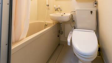 A bathroom with a bathtub, a sink, and a toilet.